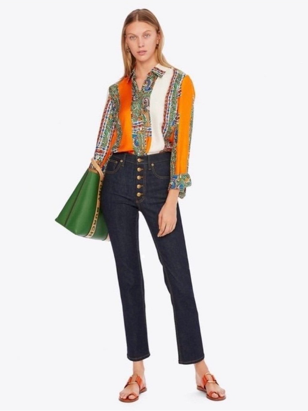Tory Burch straight-leg jeans in a dark wash resin rinse with exposed buttons.